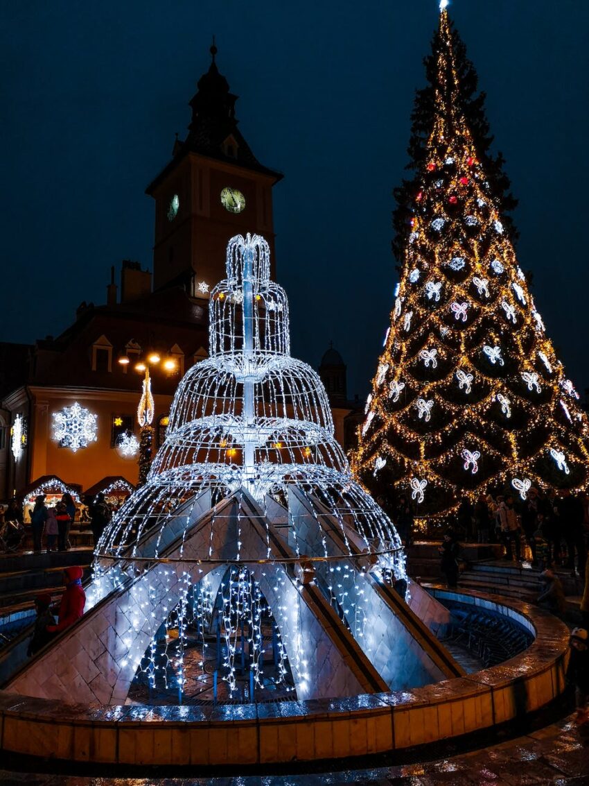 lighted fountain near christmas tree