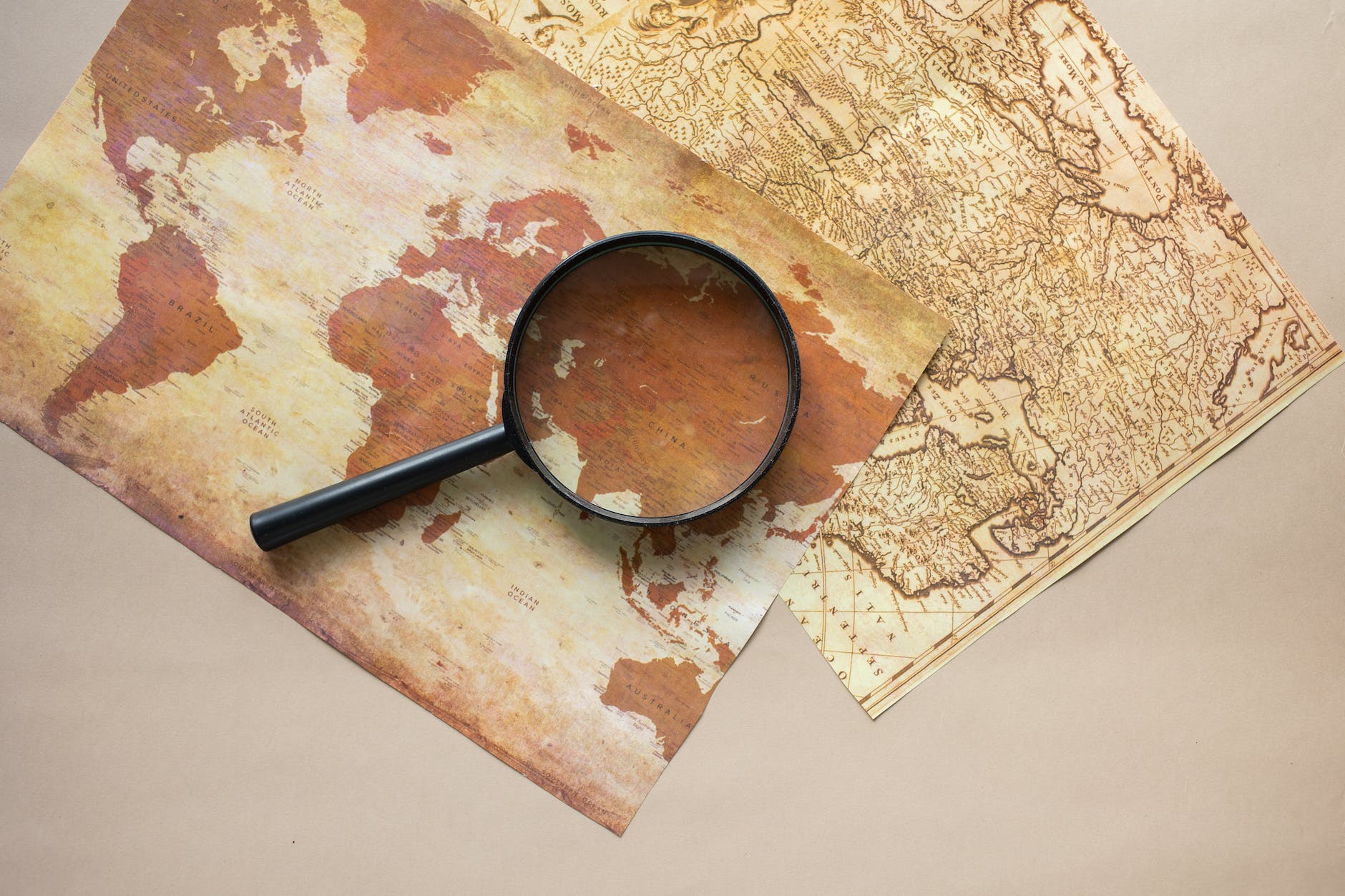 magnifying glass placed on maps