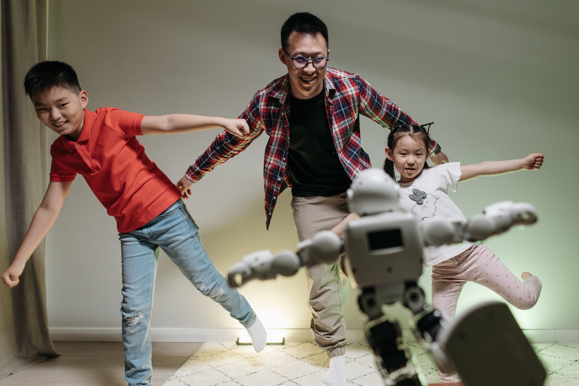 a happy family dancing with the robot