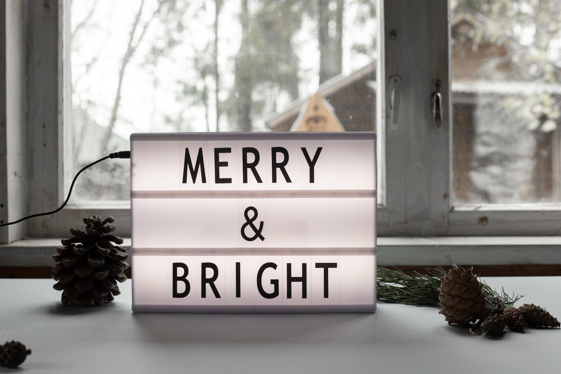 merry and bright title on electric signboard on windowsill