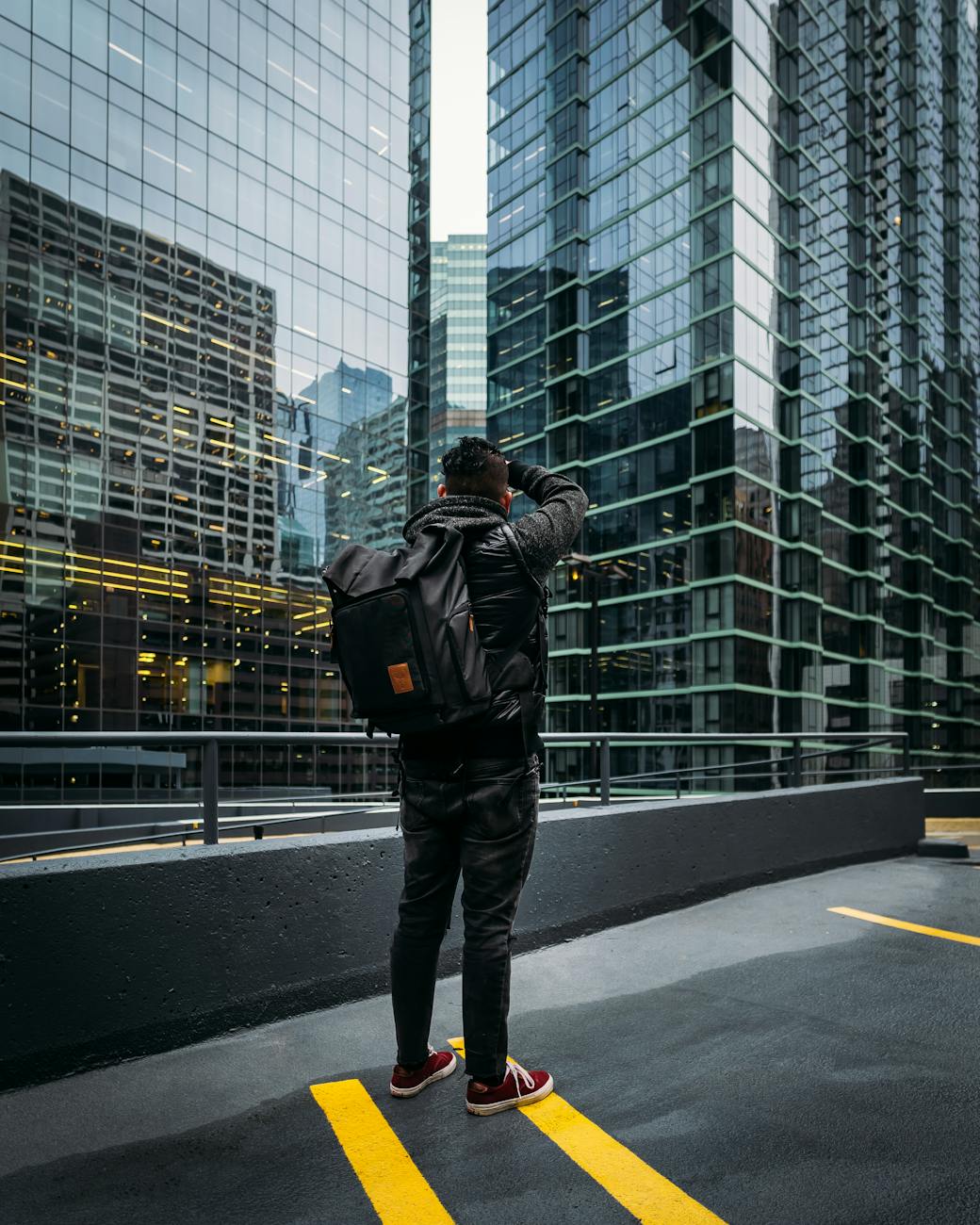 photo of man standing near high rise building